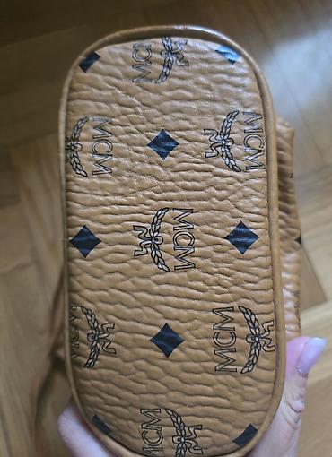 Modni rančevi: MCM mini stark ranac konjak braon boje sa monogram printom. Nov je — 2