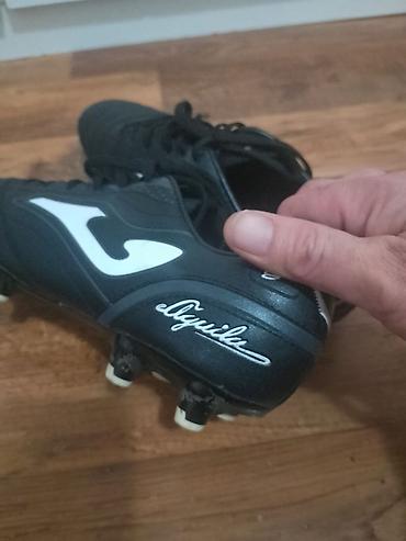 Kopačke: Kopačke Joma Aguila – crno‑bele - Model: Joma Aguila (logo i natpis — 14