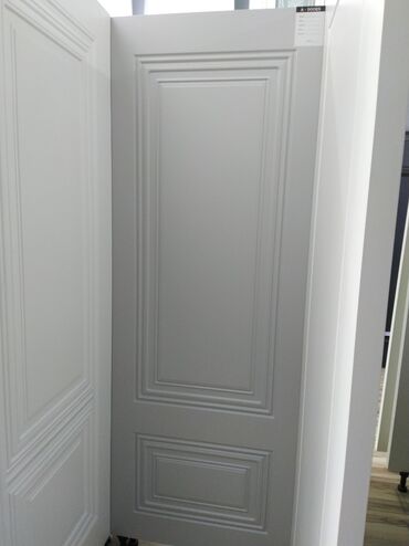 işlənmiş qapi: Ağ rəngdə, klassik dizaynlı qapı. Qapının səthi panellərlə