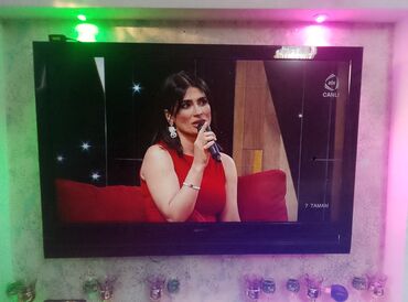 Televizorlar: Qara rəngli, divara quraşdırılmış televizor. Ekran genişdir və müasir