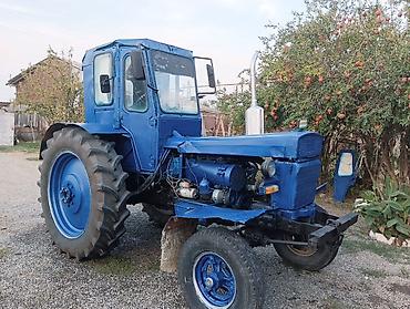 Mavi rəngdə tək kabinəli təkərli traktor. Texniki xüsusiyyətlər və