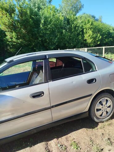 митсибуси кольт: Продается седан Mitsubishi Lancer серебристого цвета. Автомобиль имеет