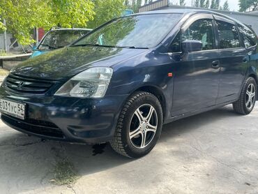 гидравлика руля: Автомобиль Honda Stream в синем цвете, относящийся к классу минивэнов