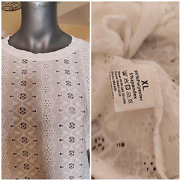 Bela ženska bluza sa dugim rukavima, čipkanog/vezenog uzorka. Okrugli