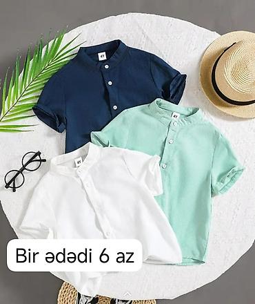 qara koynək: Uşaq köynəkləri – qısaqol, yaxası stend tipli, düyməli model. - — 1