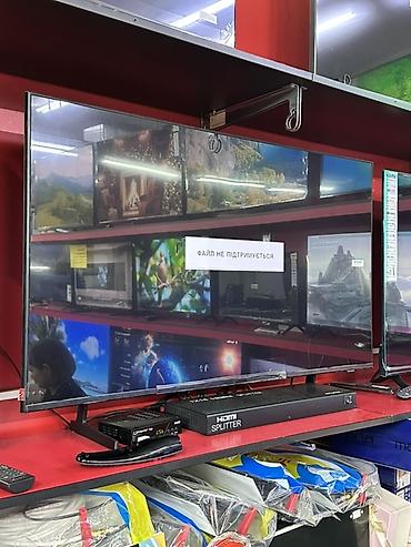 Телевизор с плоским экраном, диагональ примерно 55–60". Тонкие рамки