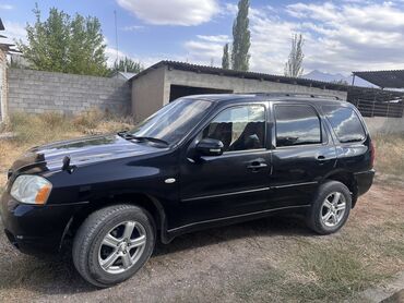 разбор тракторов: Черный кроссовер Mazda Tribute — это пятидверный автомобиль с