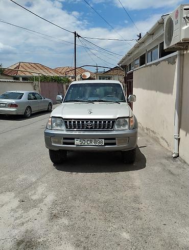 prado farası: Gümüşü rəngdə Toyota Prado SUV avtomobili. Avtomobilin arxa hissəsində — 1