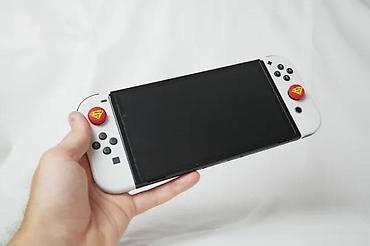 Nintendo Switch: U ponudi je Nintendo Switch OLED (čipovan). Memorija: 256 GB + 64 GB — 13