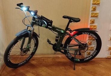 Спортивные сумки: STEL SPORT markalı, tünd yaşıl rəngdə qatlanan dağ velosipedi. Bu