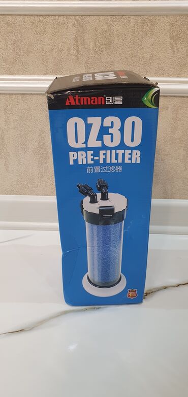 Akvarium aksessuar və ləvazimatları: Ağ rəngli silindrik korpusa malik akvarium xarici filtri. Qablaşdırma — 4