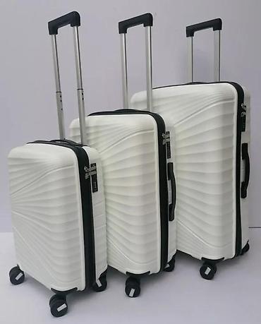 Putni koferi i torbe: === PART 1: TEXTUAL DESCRIPTION === Set od tri bela kofera sa tvrdim — 3