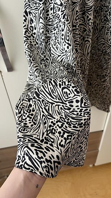 Ziyafət donları: - Məhsul: Oversize T‑shirt - Brend/Qrafika: “NEW ERA” mövzulu çap; ön — 14