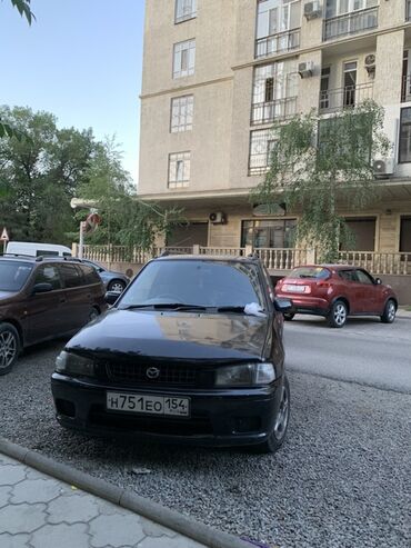 диски демио: Автомобиль Mazda Demio в черном цвете. Это компактный хэтчбек, который