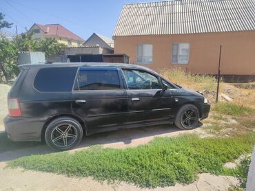 диск на некси: Минивэн Honda Odyssey черного цвета, модель RA6/RA7, оснащенный