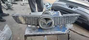 Решетки радиатора: Решетка радиатора Mazda Оригинал — 10