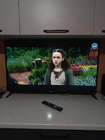 Телевизор LED с тонкими рамками, диагональ примерно 43–50". Чёткая