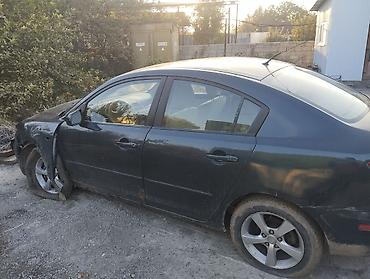 Mazda: Mazda 3, седан (поколение BK). Цвет темно‑серый/черный. Бензин автомат — 2
