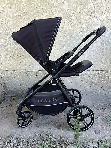 Прогулочная коляска New Lux - Легкая и маневренная рама с поворотными