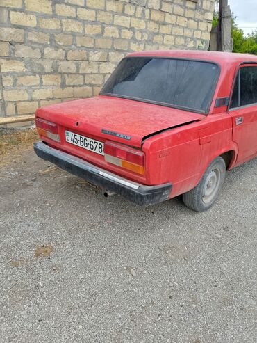 Lada 2107 modeli, qırmızı rəngdə sedan üslubunda, dörd qapılı və arxa