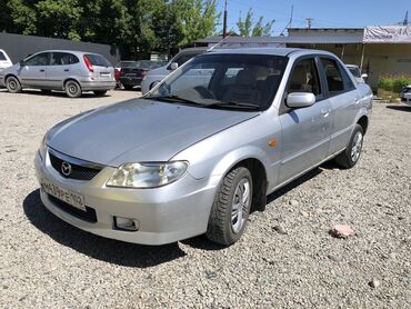 машина чехол: Mazda Familia: 2003 г., 1.5 л, Автомат, Бензин, Седан