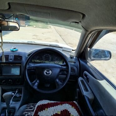 дом в машине: Mazda Familia: 2001 г., 1.3 л, Автомат, Бензин, Седан