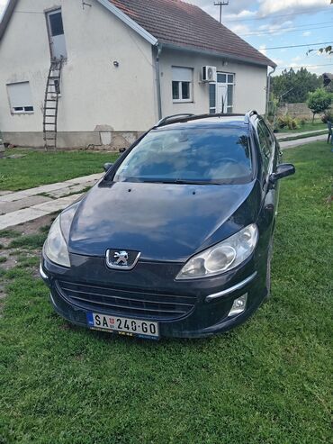 belgrade car sales: Peugeot 407 SW karavan u crnoj boji. Vozilo ima krovne nosače i alu