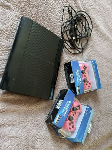 işlenmiş qaz: Qara rəngdə olan PlayStation 3 oyun konsolu. Komplektə iki ədəd