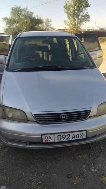 семиместные машины: Минивэн Honda Odyssey серебристого цвета, представленный на