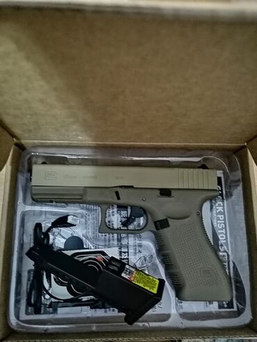 Игрушки: Пистолет Glock 19X песочного цвета. Эта модель отличается от