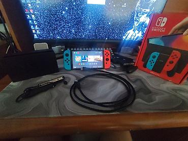 Nintendo Switch OLED: Nintendo Switch OLED, неоновые Joy‑Con (красный/синий). Комплектация — 1
