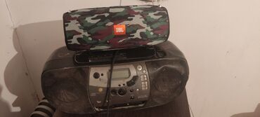 стиральная машинка б: Портативная колонка JBL с камуфляжным тканевым оформлением. -