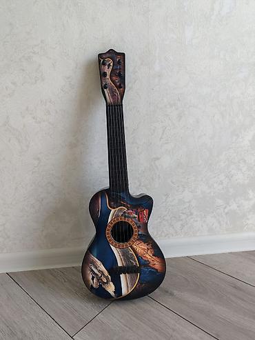 inkişaf etdirici oyuncaqlar: Dekorativ uşaq gitara formasında musiqi aləti. Korpus üzərində — 1