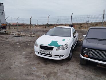 Digər Avtomobillər: Ağ rəngli sedan tipli avtomobil, qismən yaşıl rəngli boya izləri ilə