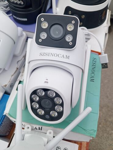 Видеонаблюдение: Ağ rəngdə olan Szinocam markalı PTZ təhlükəsizlik kamerası. Kamera