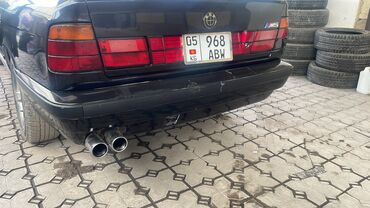 мерс 1990: Задний Бампер BMW 1990 г., Б/у, цвет - Черный, Оригинал