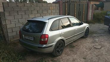 стекло боковые: Mazda 323: 1999 г., Механика, Бензин, Универсал — 1