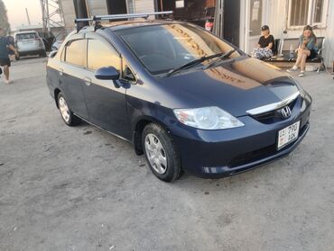 ролс ройс машина: Автомобиль Honda Aria тёмно-синего цвета, оснащённый багажником на