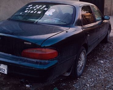 Kia: Kia Sephia sedan - Kuzov: 4 qapılı sedan, tünd yaşıl rəng - Ön hissə — 4