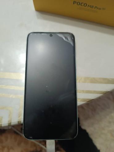 POCO M8 Pro 5G — смартфон с поддержкой 5G в фирменной жёлтой коробке — 3