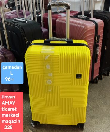 Çamadanlar: Sarı rəngli, sərt korpuslu, dörd təkərli səyahət çamadanı. Çamadanın