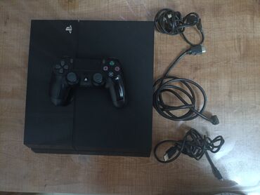 hdmi̇: Sony PlayStation 4 oyun konsolu, qara rəngdədir. Konsolun üzərində PS4