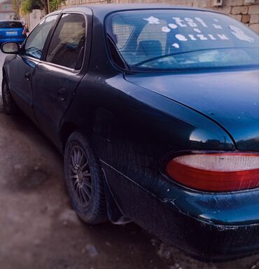 Kia: Kia Sephia sedan - Kuzov: 4 qapılı sedan, tünd yaşıl rəng - Ön hissə — 5