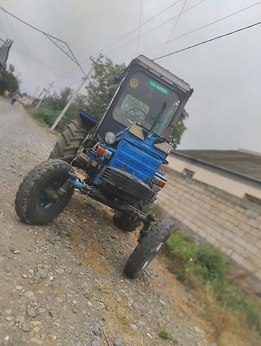 masin satis sayti: Mavi rəngli təkərli traktor - Kabinəli, geniş şüşəli görünüş: ön-yan — 2