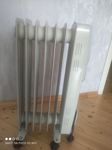 elektrikli peç: Обогреватели и камины