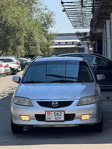миша: Mazda Familia: 2002 г., 1.6 л, Механика, Бензин, Седан — 4