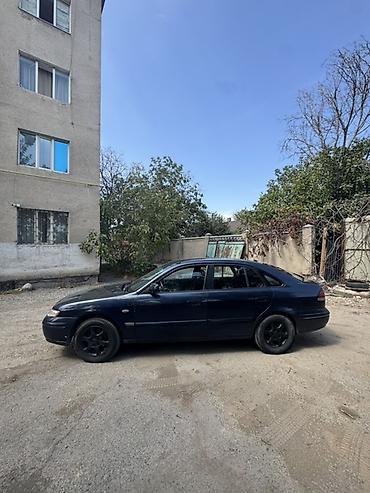 зеркела: Mazda 626: 1997 г., 1.8 л, Кол менен иштөөчү, Седан — 6