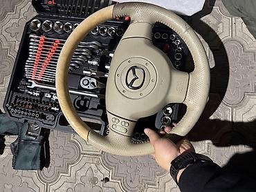 Рулевое колесо Mazda, светло-бежевое (кожа/перфорация), с модулем
