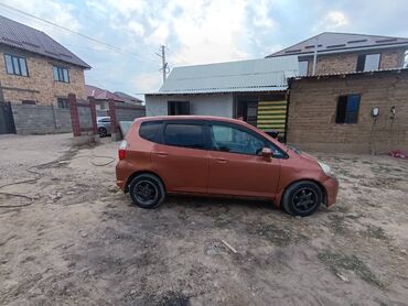 обмен на малолетражку: Автомобиль Honda Fit оранжевого цвета, представленный в кузове