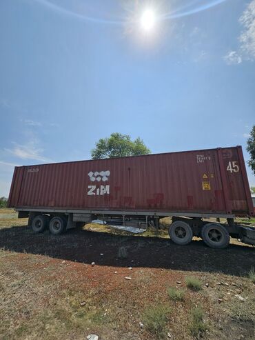 продаю контейнер дордой восток: Длинный красный грузовой контейнер ZIM, предназначенный для перевозки